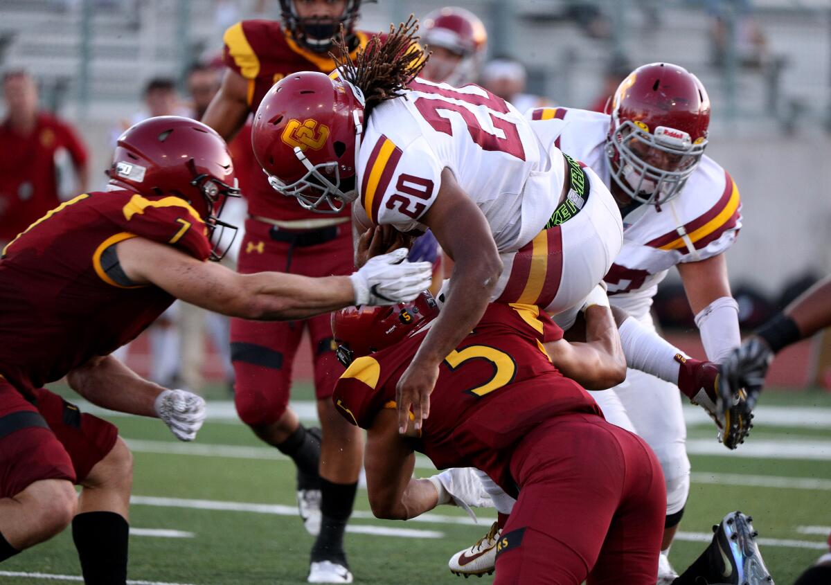 Glendale College running back Adayus Robertson is upended in away game at Robinson Stadium, at Pasadena City College in Pasadena on Saturday, Sept. 14, 2019.