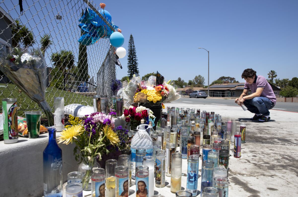 Daniel Flores, 18, at makeshift memorial for Omar Marquez Jr., 15