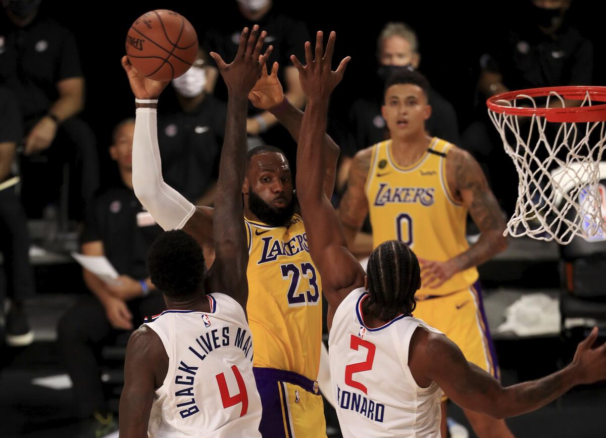 Lakers forward LeBron James is double-teamed in the fourth quarter Thursday.