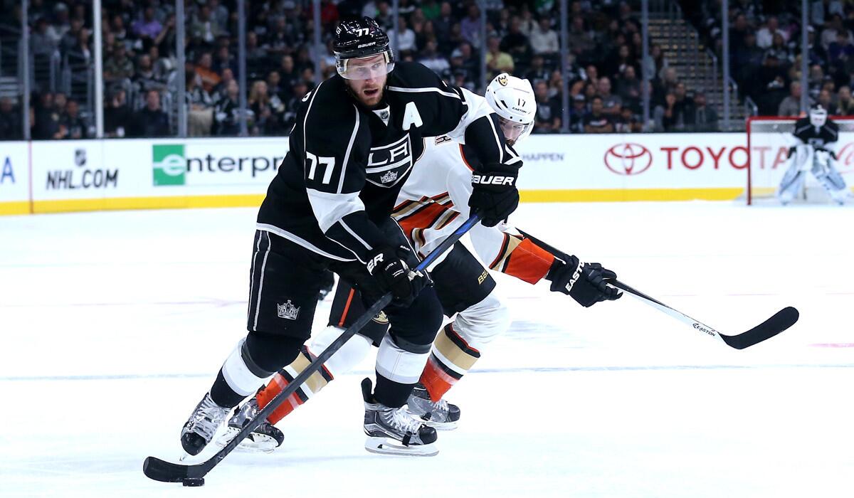 Kings' Jeff Carter controls the puck in front of Ducks' Ryan Kesler during a preseason game at Staples Center on Tuesday.