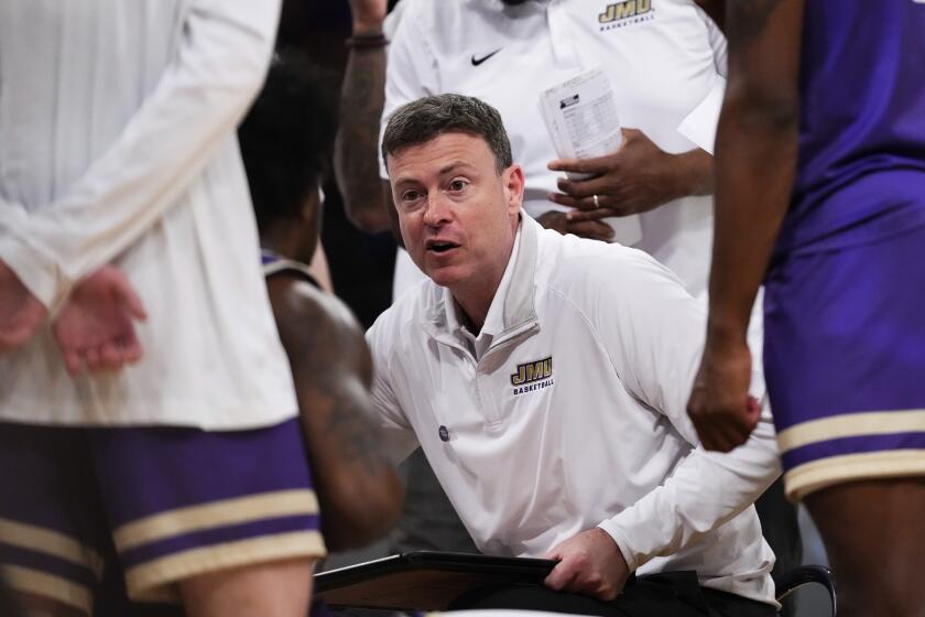 James Madison head coach Mark Byington talks to his team during a time-out in the second half of a second-round college basketball game against Duke in the NCAA Tournament Sunday, March 24, 2024, in New York. (AP Photo/Frank Franklin II)