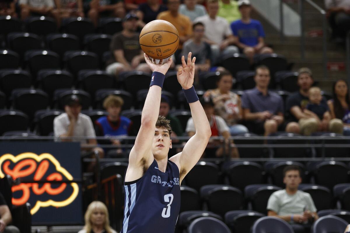 Memphis Grizzlies forward Jake LaRavia shoots a 3-pointer against the Philadelphia 76ers during the first quarter of an NBA summer league basketball game Tuesday, July 5, 2022, in Salt Lake City. (AP Photo/Jeff Swinger)
