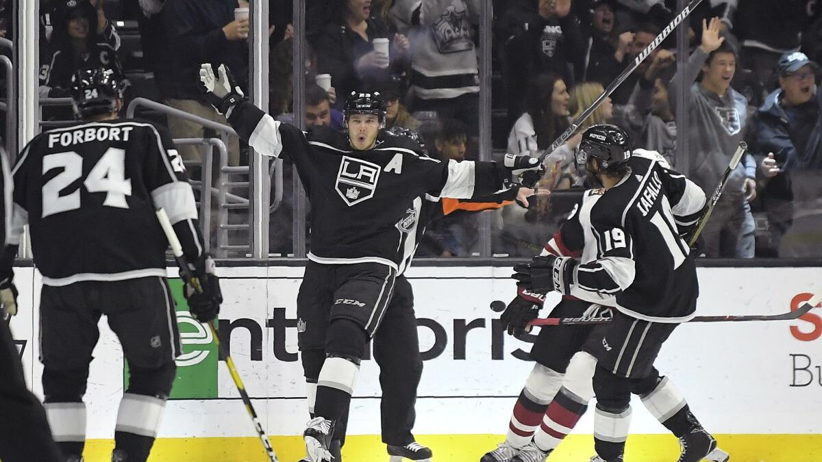 Kings right wing Dustin Brown, center, celebrates his goal with defenseman Derek Forbort, left, and left wing Alex Iafallo during the third period.