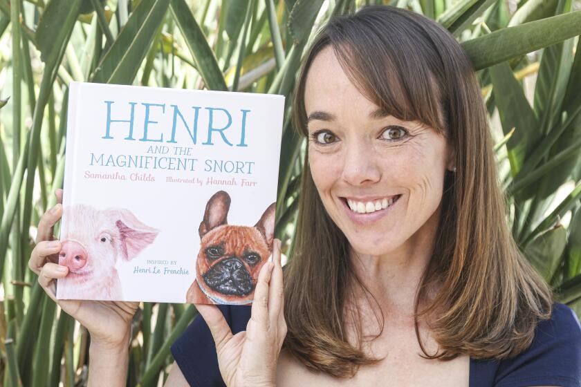Solana Beach, CA - June 21: CHildren's book author Samantha Childs poses for photos with her book "Henri and the Magnificent Snort" at her home on Wednesday, June 21, 2023 in Solana Beach, CA. (Eduardo Contreras / The San Diego Union-Tribune)