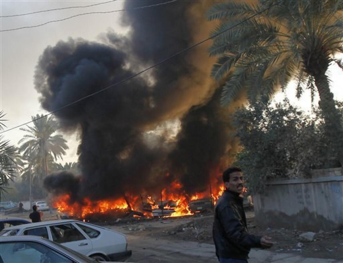 An Iraqi man reacts at the site of a car bomb attack in Baghdad, Iraq, Tuesday, Dec. 15, 2009. A series of car bombs ripped through downtown Baghdad near the heavily fortified Green Zone. (AP Photo/Hadi Mizban)
