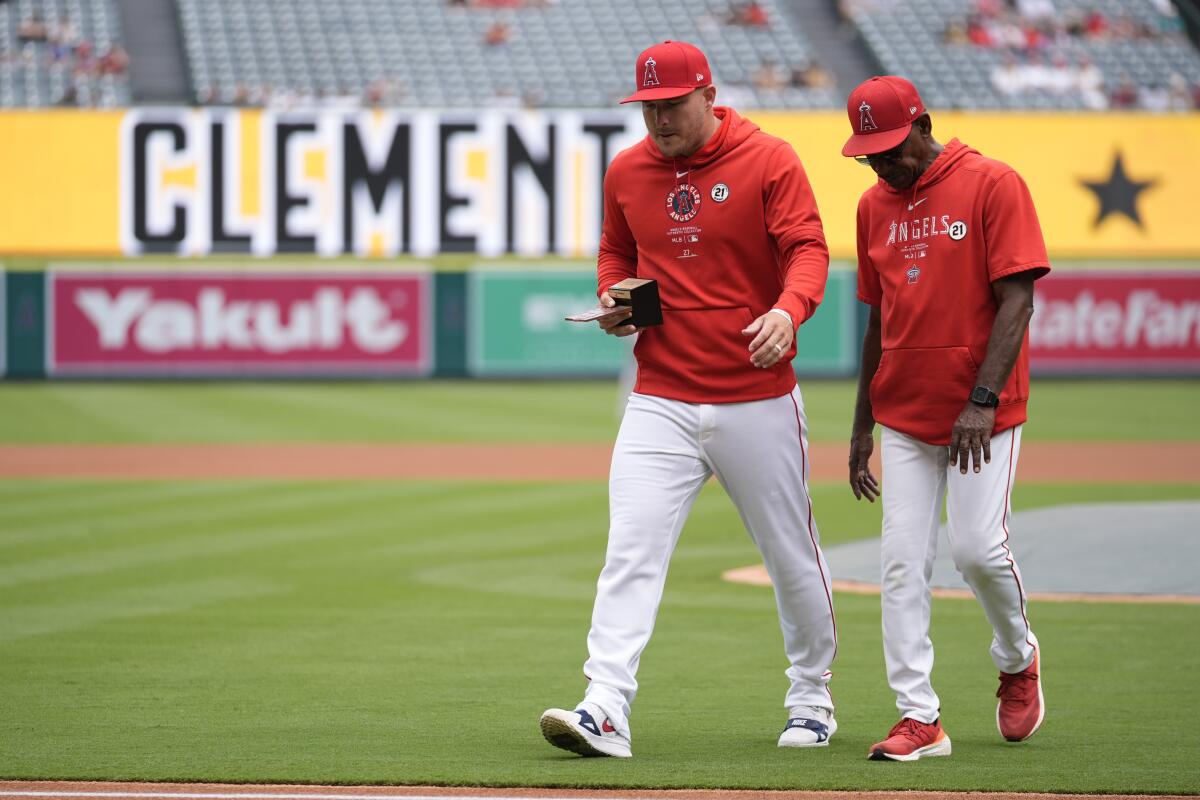 Los Angeles Angels' Mike Trout, left, is recognized as the Angels' 2024 Roberto Clemente Award nominee.