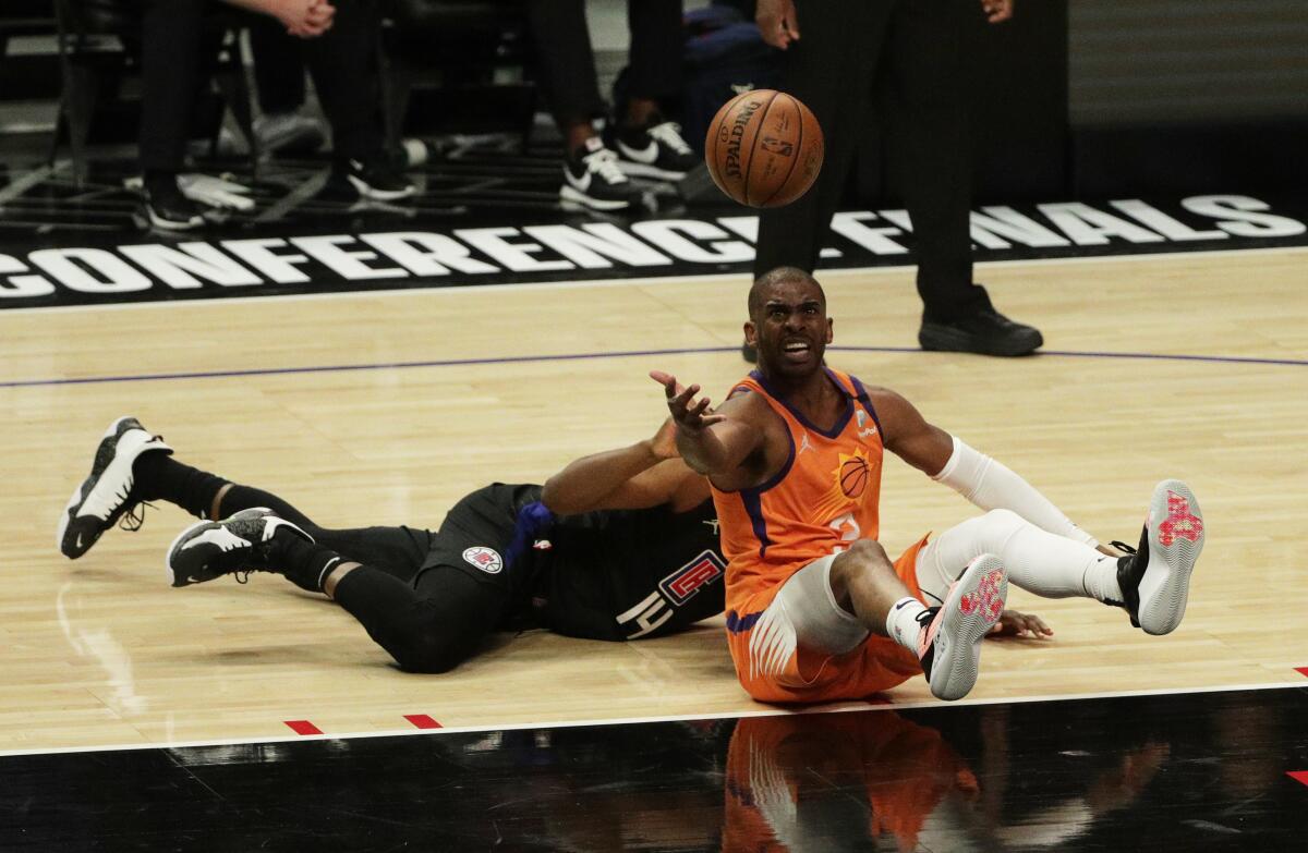 Suns guard Chris Paul wins the battle for a loose ball against Clippers guard Terance Mann during Game 6.