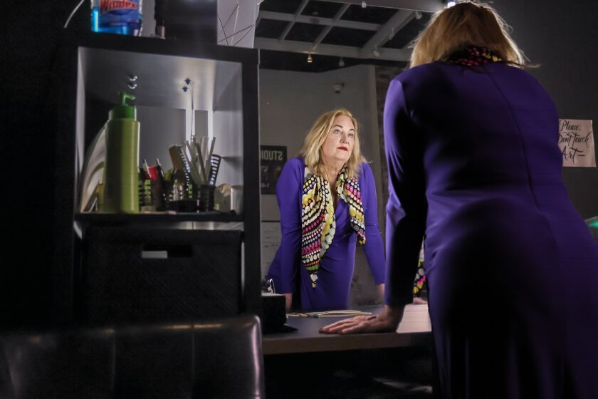 Dr. Erica Anderson, a transgender clinical psychologist, is at the makeup mirror during a break from filming a pilot for a TV show on Thursday, April 7, 2022, in Oakland, Calif.