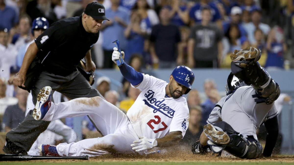 Dodgers right fielder Matt Kemp, center, scores past San Diego Padres catcher Rene Rivera as umpire Chad Fairchild, left, looks on during the Dodgers' 8-6 win Tuesday.