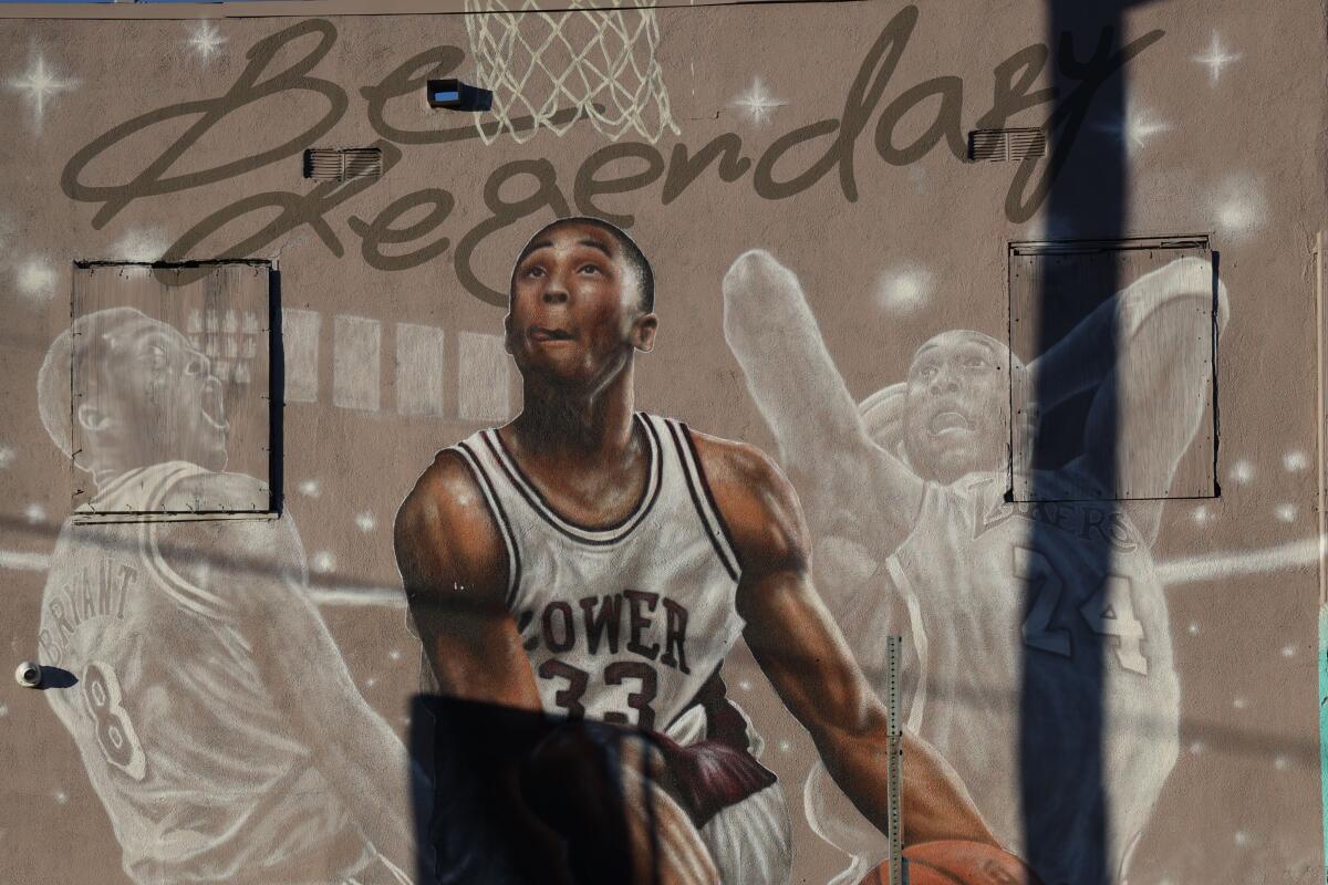 Mural shows Kobe Bryant wearing his No. 33 Lower Merion High uniform and of him in his No. 8 and No. 24 Laker jerseys.