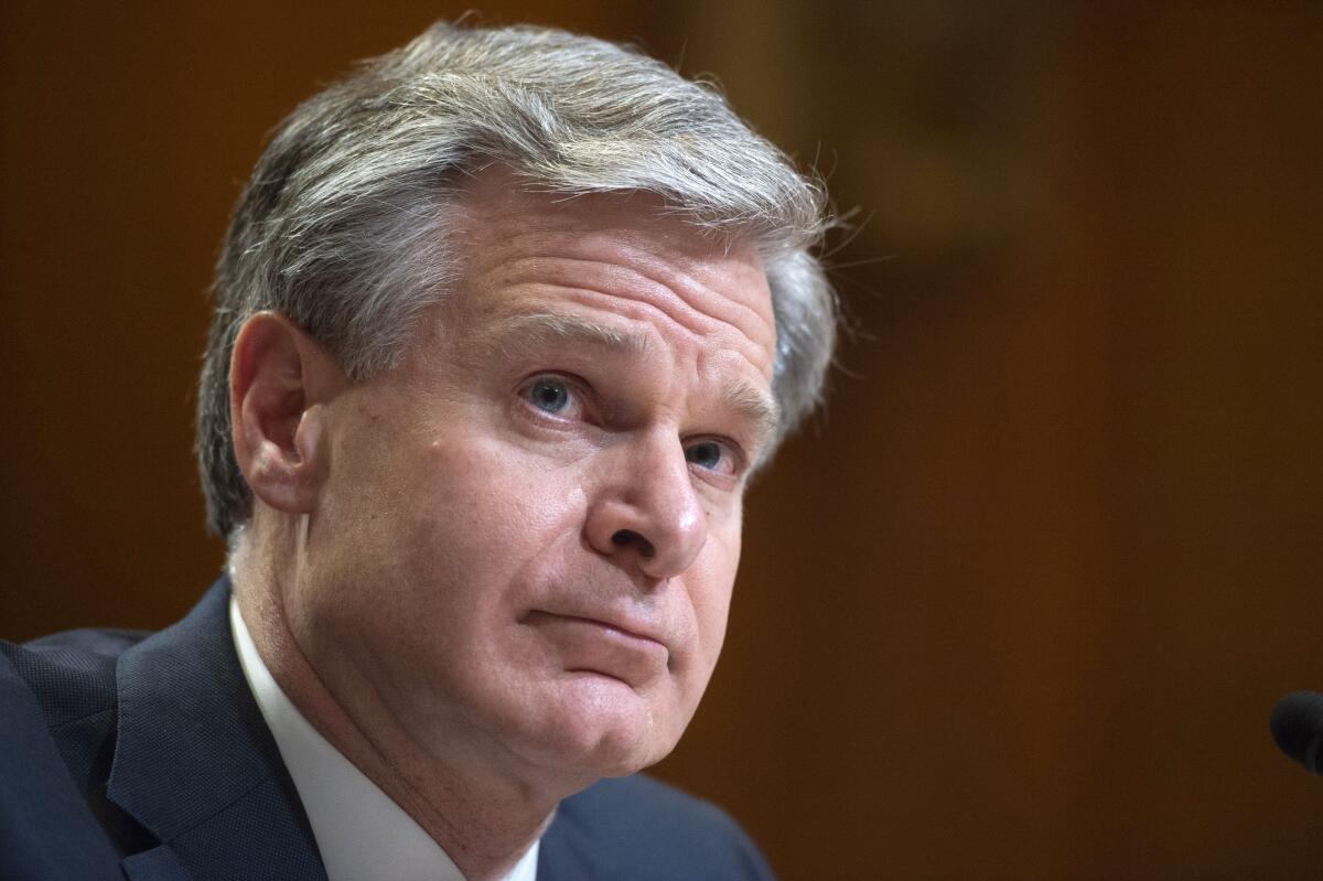 Christopher A. Wray pauses during a hearing.