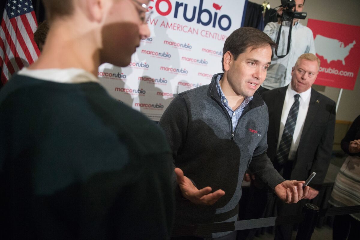 Republican presidential candidate Sen. Marco Rubio of Florida greets guests during a town hall meeting over the weekend in Cedar Rapids, Iowa. His stand on immigration will need to be clarified before the campaign hits the swing states of Colorado and Nevada.