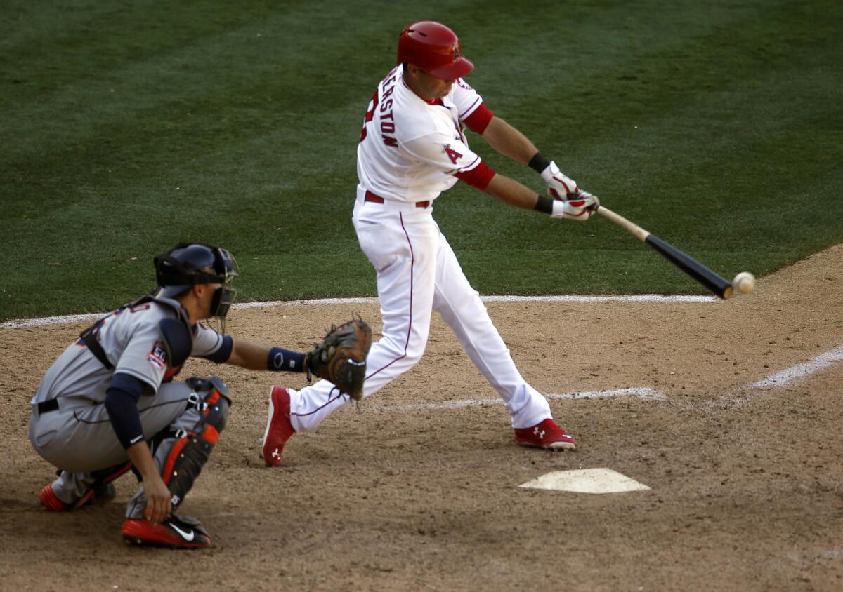 Angels third baseman Taylor Featherston hits a walk-off single to beat the Houston Astros, 2-1, in the 13th inning.