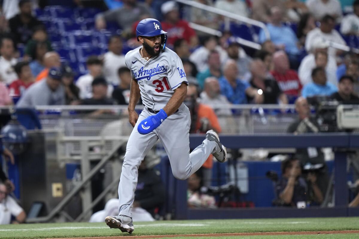 Dodgers' Amed Rosario heads home to score on a single by Chris Taylor.