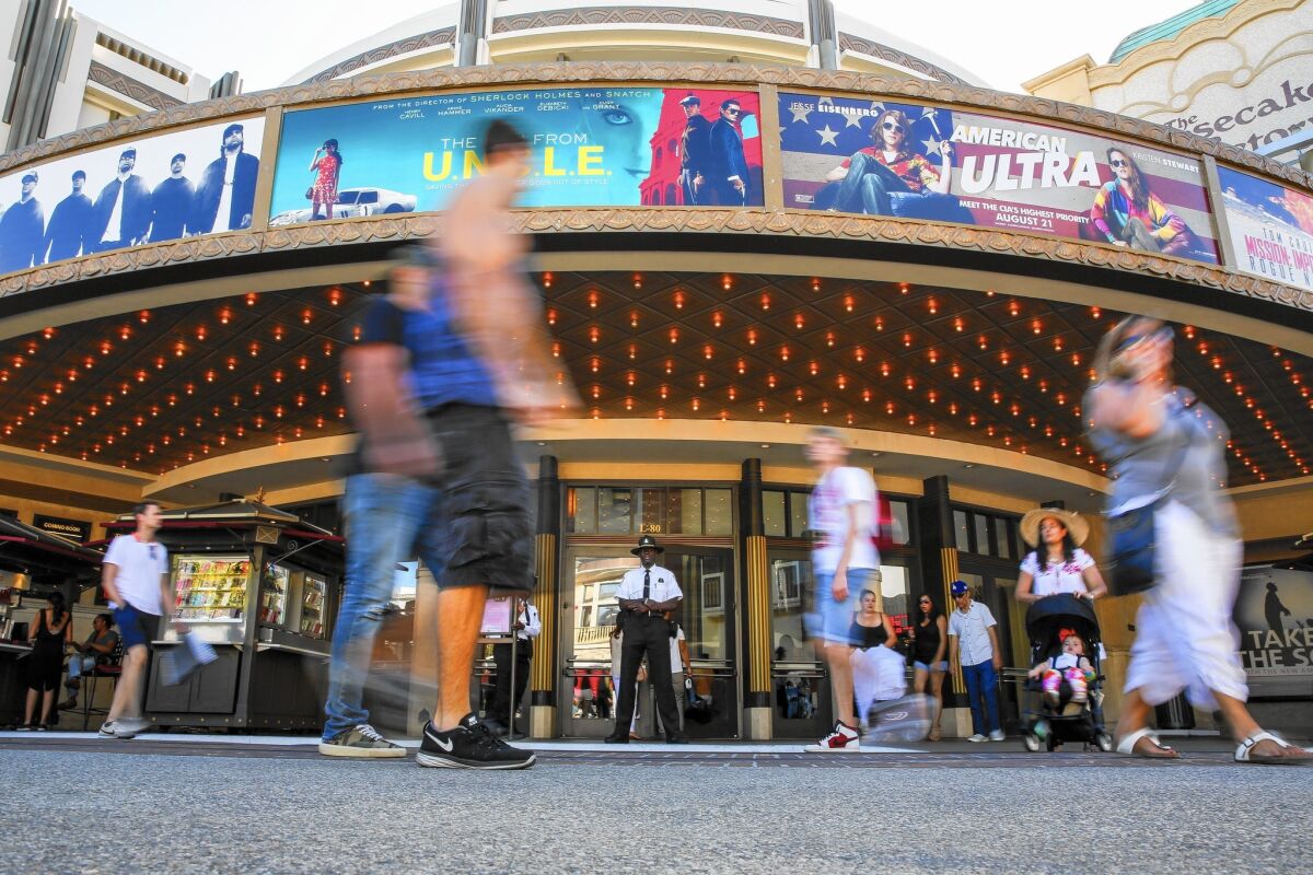 Moviegoers gather outside the Pacific Theatres at the Grove shopping center on Sunday as the summer box-office season nears its end.