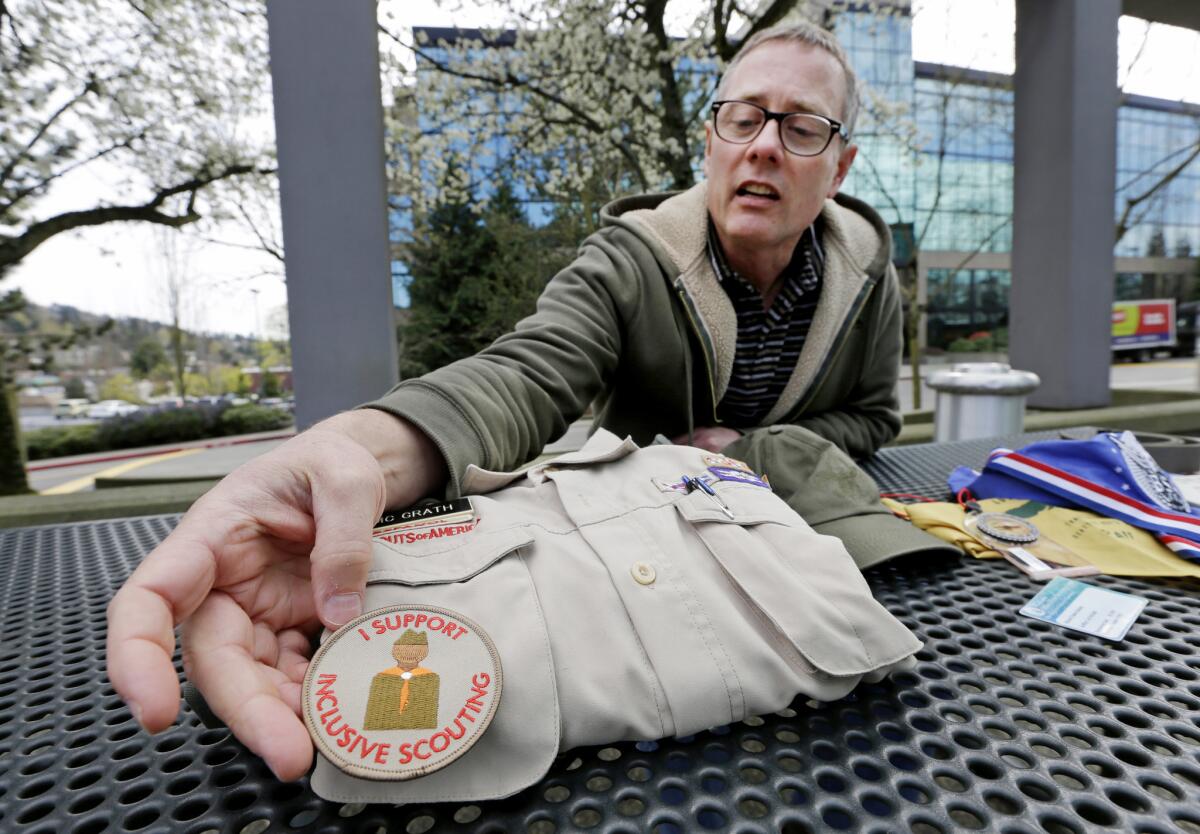 Geoff McGrath points out an "inclusive scouting" badge worn on his Boy Scout scoutmaster uniform shirt for the Seattle troop he led. The Boys Scouts of America has removed McGrath, an openly gay troop leader.