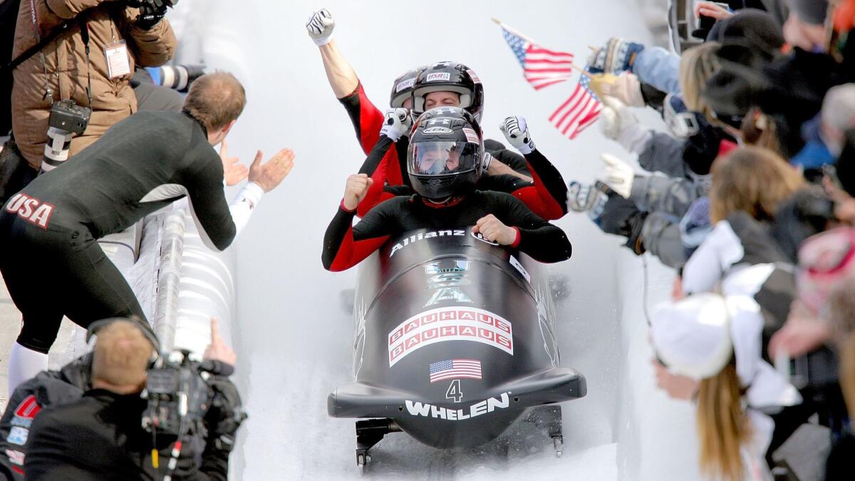 Members of USA 1, piloted by Steven Holcomb, celebrate after crossing the finish line to win the four man competition during the FIBT Bobsled World Championships at the Olympic Complex March 1, 2009 in Lake Placid, New York.