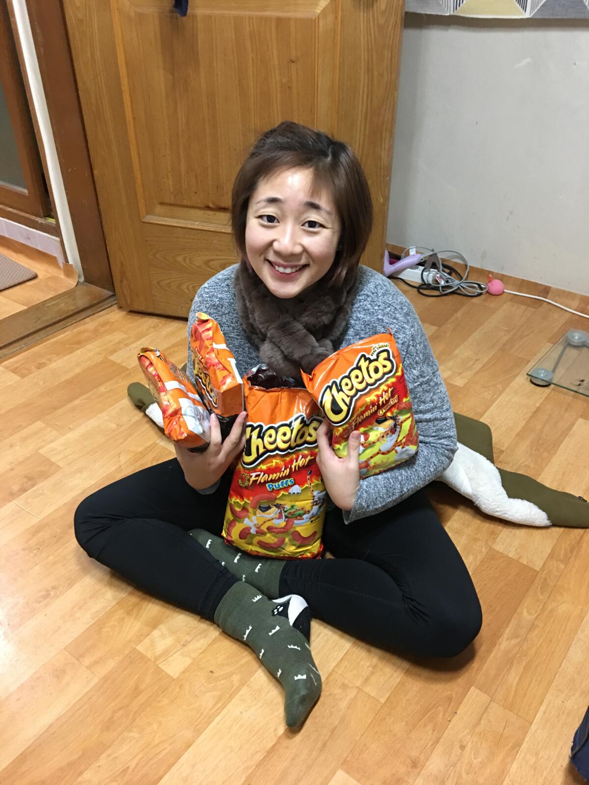 Vivian Oh, in Seoul receiving a haul of Flamin’ Hot Cheetos all the way from California.