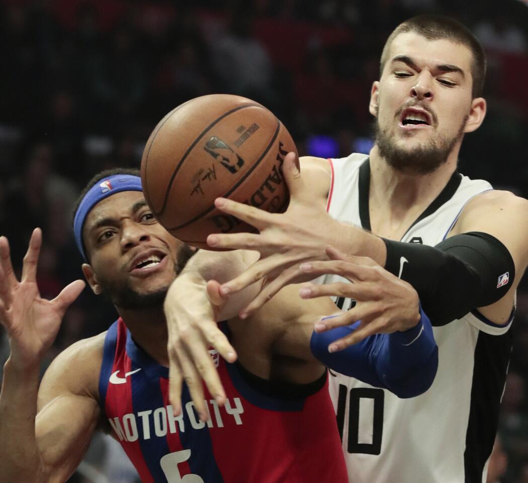 Clippers center Ivica Zubac, right, battles Detroit Pistons guard Bruce Brown for a rebound during the first half.