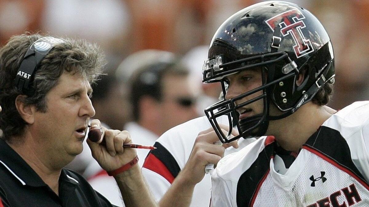 Former Texas Tech coach Mike Leach, left, talks with then-Texas Tech quarterback Graham Harrell during the second quarter of a game in Austin, Texas, on Nov. 10, 2007.