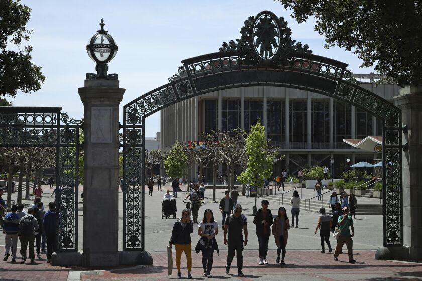 FILE - In this May 10, 2018, file photo, students walk past Sather Gate on the University of California at Berkeley campus in Berkeley, Calif. The University of California, Berkeley has received a $252 million donation, its largest-ever single gift to start construction of a new building for students and faculty studying computing and data science. The gift, made anonymously, will allow the university to start building the Data Hub on the north side of campus, the San Francisco Chronicle reported Monday, March 2, 2020. (AP Photo/Ben Margot, File)