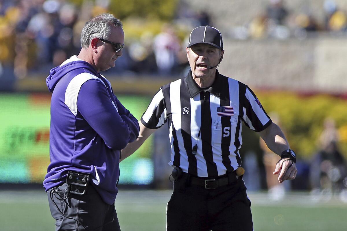 TCU coach Sonny Dykes speaks with an official during the second half of an NCAA college football game against West Virginia in Morgantown, W.Va., Saturday, Oct. 29, 2022. (AP Photo/Kathleen Batten)