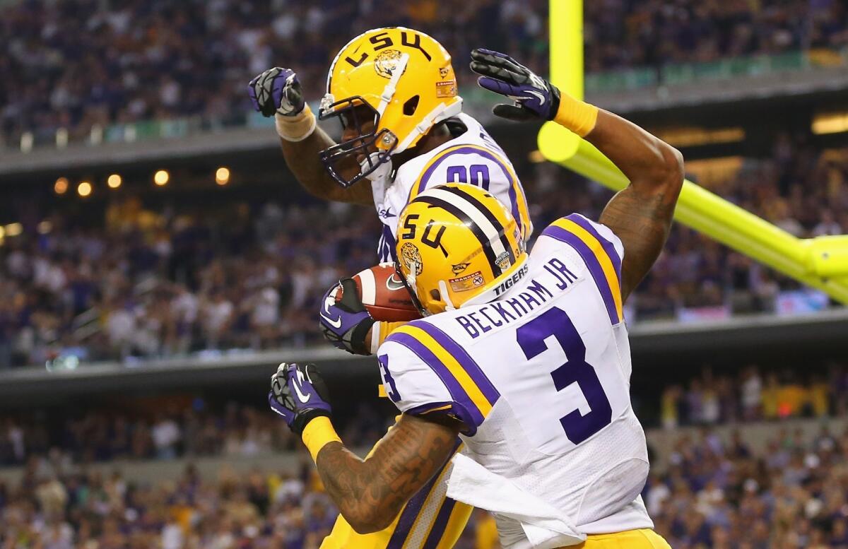 LSU wide receiver Jarvis Landry, top, celebrates with teammate Odell Beckham after scoring a touchdown in the Tigers' 37-27 victory over TCU on Saturday.