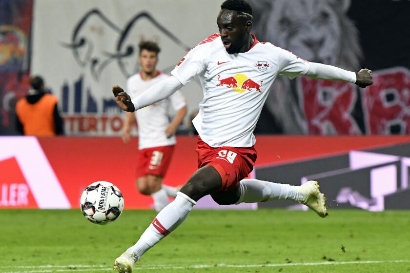 FILE - Leipzig's Jean-Kevin Augustin scores his side's 2nd goal during the German first division Bundesliga soccer match between RB Leipzig and VFB Stuttgart in Leipzig, Germany, Wednesday, Sept. 26, 2018. English soccer club Leeds is going to sport’s highest court for a second appeal case involving former striker Jean-Kévin Augustin. (AP Photo/Jens Meyer, File)