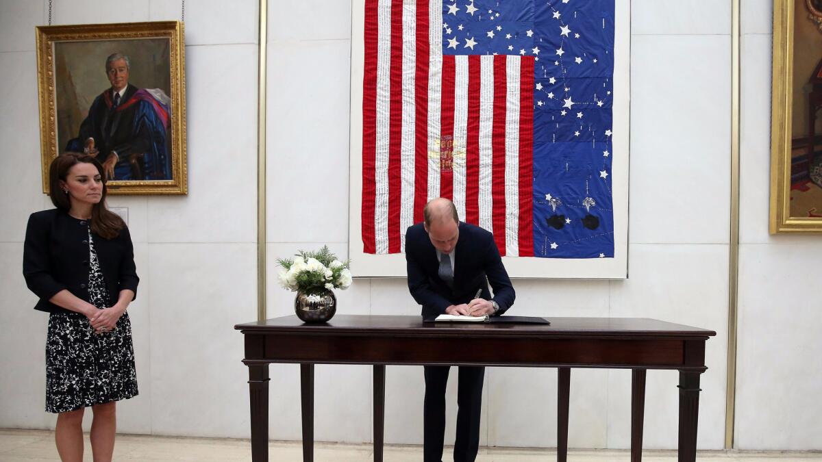 Britain's Prince William signs a book of condolence for the Orlando, Fla., nightclub shooting victims at the U.S. Embassy in London with Kate, duchess of Cambridge.