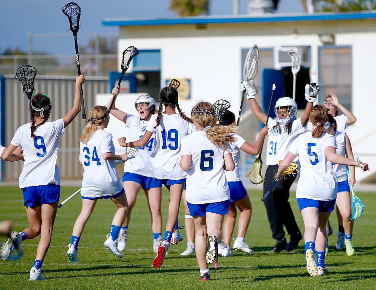 Palisades players celebrate after winning City Section girls' lacrosse title.