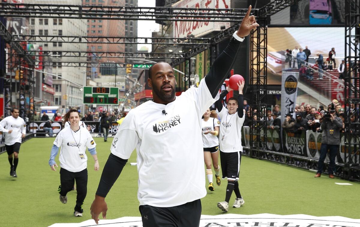 Donovan McNabb, shown playing kickball with the American Honey Bar-sity Athletics in Times Square, wants to retire from the NFL as a member of the Philadelphia Eagles.