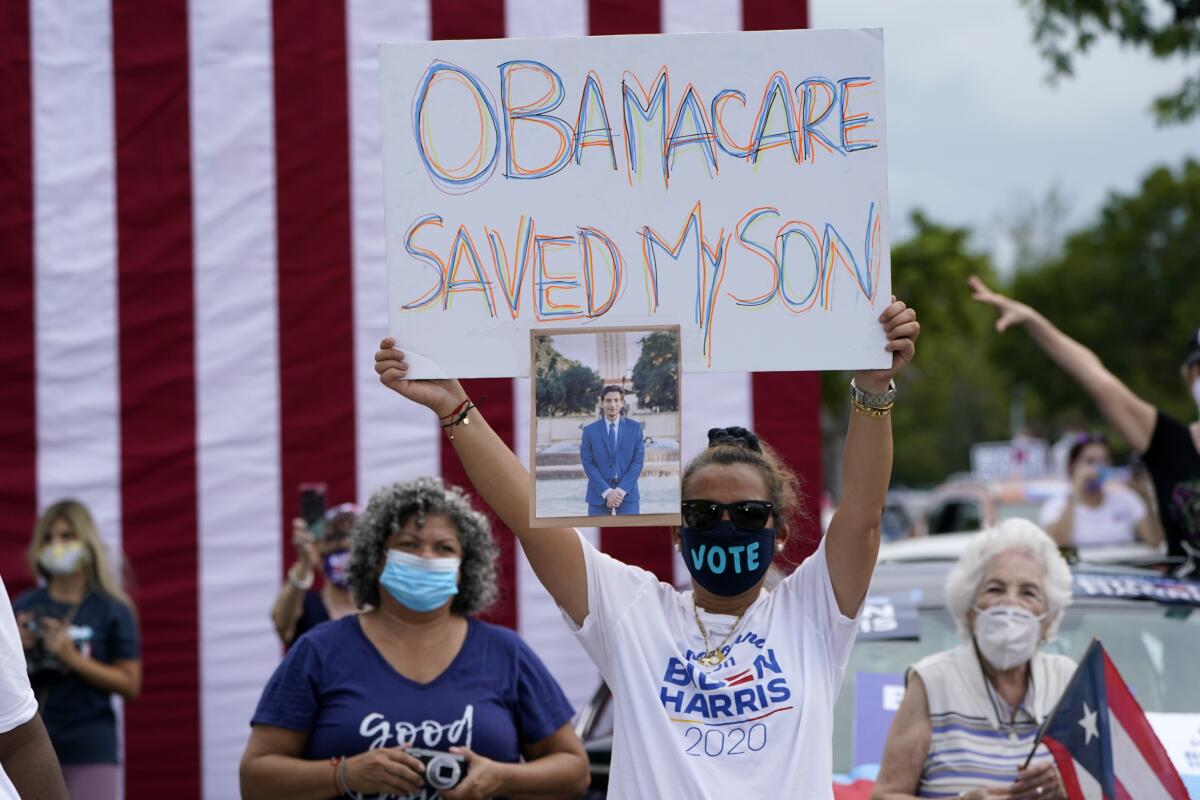 Adelys Ferro holds a sign in support of Obamacare