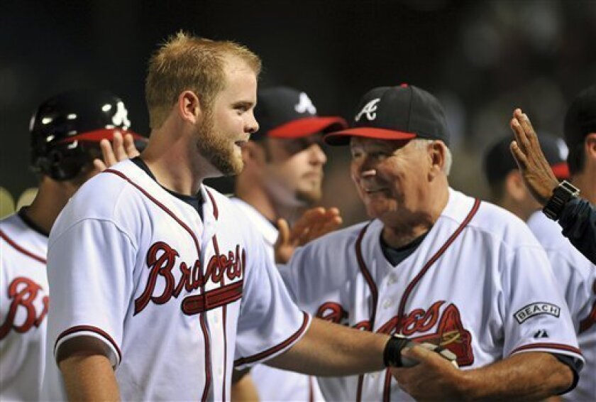 Atlanta Braves Brian McCann, left celebrates his game winning RBI against the Seattle Mariners with Braves manager Bobby Cox, right, after a baseball game, Saturday, June 21, 2008, at Turner Field in Atlanta. The Braves won 5-4. (AP Photo/Gregory Smith)