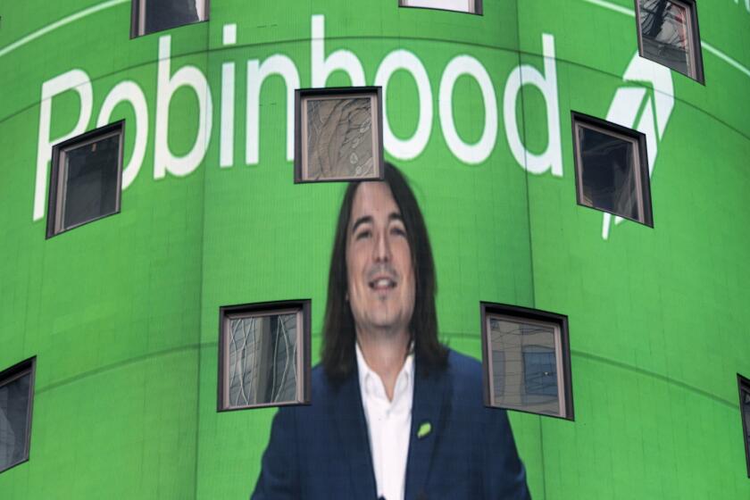 FILE - Vladimir Tenev, CEO and co-founder of Robinhood, is shown on an electronic screen at Nasdaq in New York's Times Square following his company's IPO, Thursday, July 29, 2021. Robinhood's stock is flying again Wednesday, Aug. 4, jumping so much that trading was temporarily halted three times in the first half hour after the market opened. (AP Photo/Mark Lennihan, File)