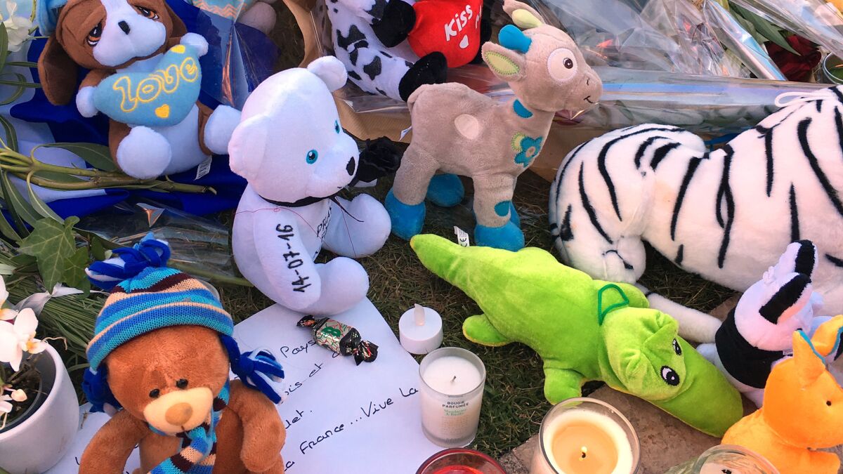 Stuffed toys at a makeshift memorial are reminders of the children killed and injured.