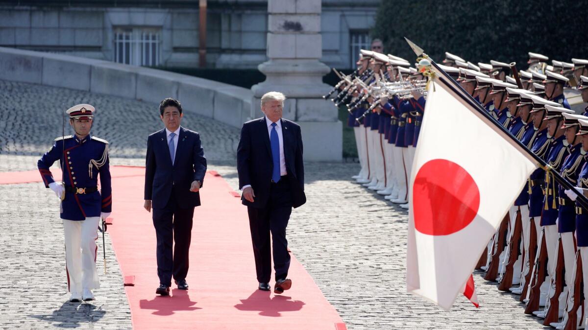 President Trump and Japanese Prime Minister Shinzo Abe review an honor guard during a welcome ceremony at Akasaka Palace in Tokyo on Nov. 6, 2017.