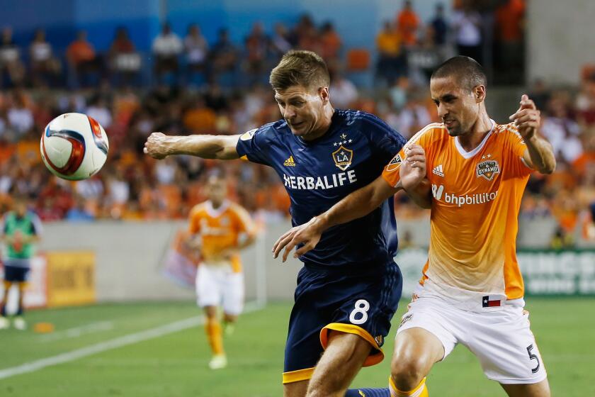 Steven Gerrard, left, battles for the ball with the Dynamo's Raul Rodriguez during the Galaxy's 3-0 loss on Saturday night in Houston.