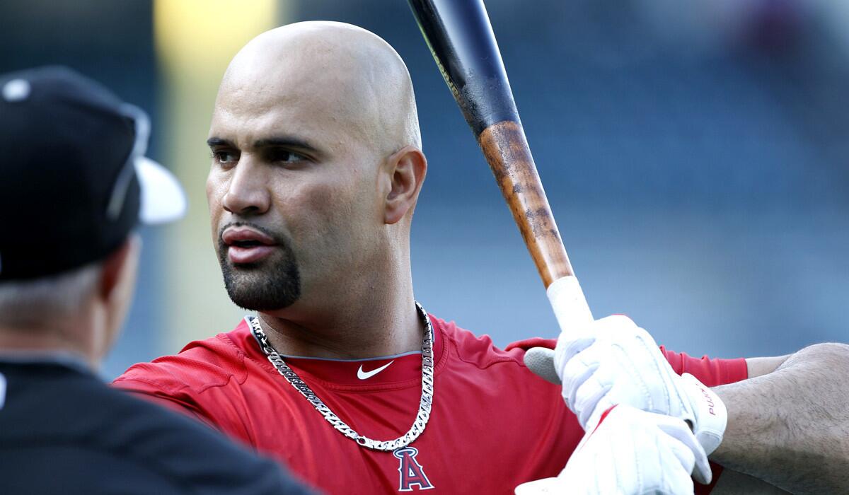 Los Angeles Angels' Albert Pujols, right, talks to Chicago White Sox third base coach Joe McEwing during warm ups before a game against the Chicago White Sox on Thursday.