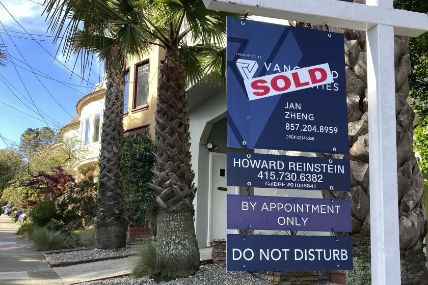 A notice indicating that a home has been sold appears on a sign in residential section of San Francisco, Friday, April 21, 2023. (AP Photo/Jeff Chiu)