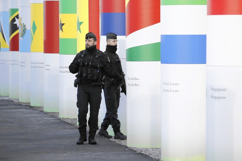 French police officers patrol outside the main entrance of the United Nations Climate Change Conference in Paris.