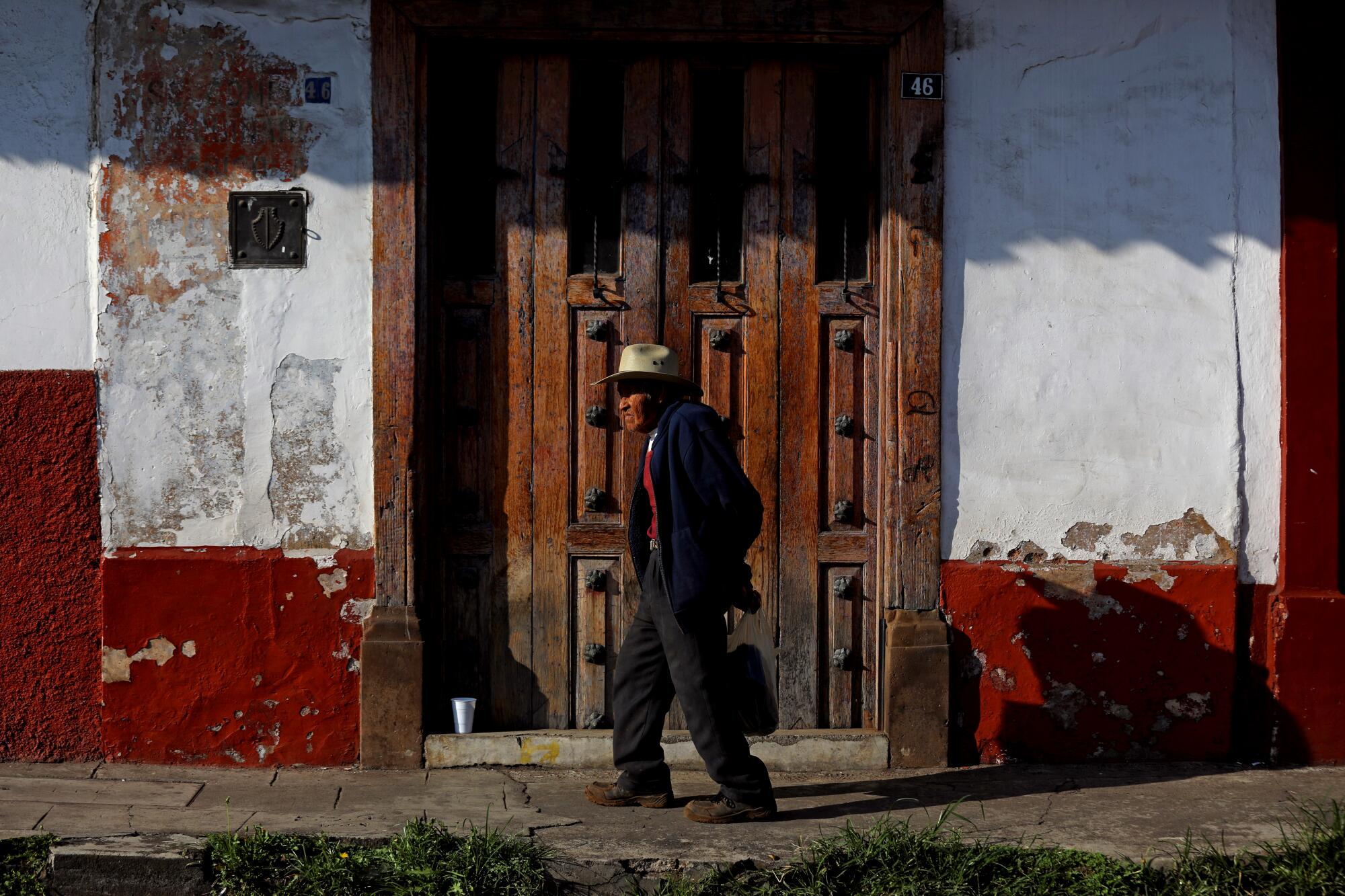 A man walks down the street in the historic center of Pátzcuaro, Michoacán. 