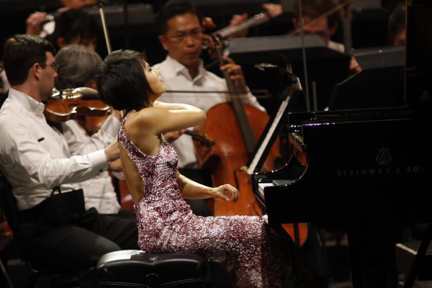 Pianist Yuja Wang performs Ravel's Concerto in G with the Los Angeles Philharmonic conducted by Gustavo Dudamel at the Hollywood Bowl on Thursday night.