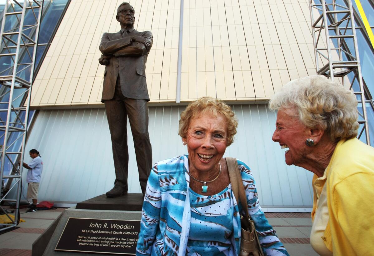 Nan Wooden, left,  enjoys a light moment with friend Mary Lou Smith at the unveiling of her father John Wooden's statue.