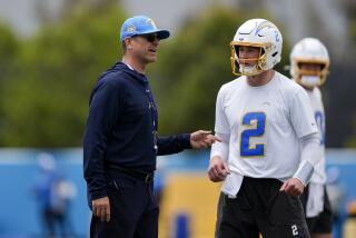 Chargers coach Jim Harbaugh talks to  quarterback Easton Stick (2).