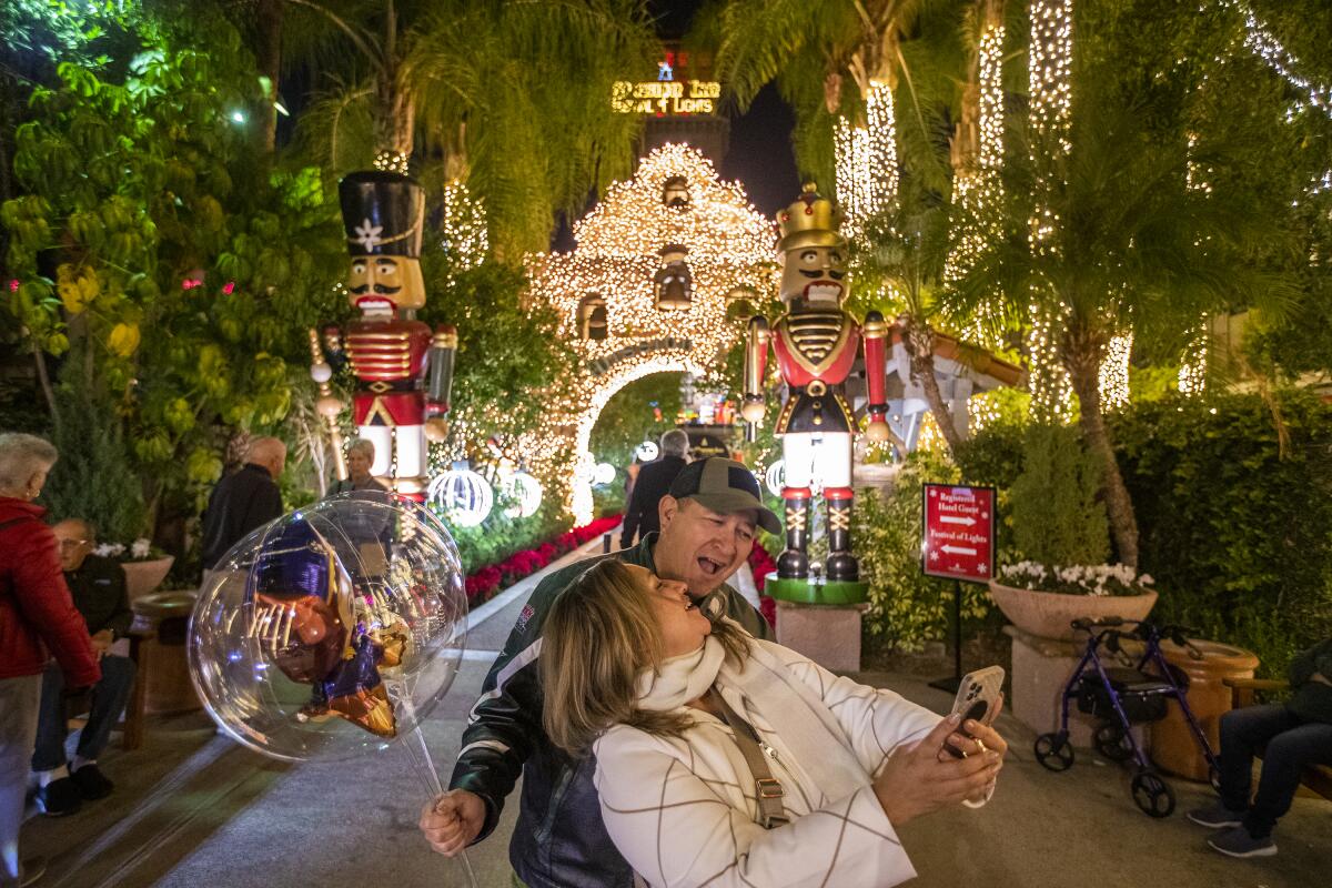  A couple looks at Christmas lights at the Mission Inn Hotel.
