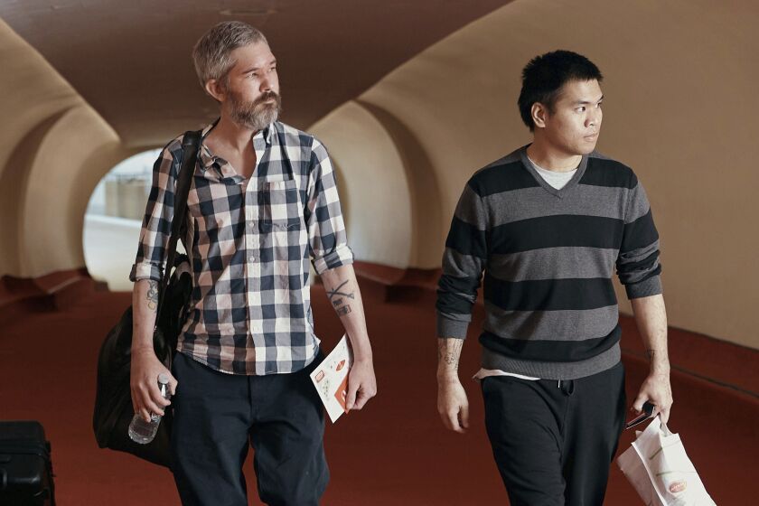 American's Andy Huynh, right, and Alex Drueke arrive at the TWA Hotel on Friday, Sept. 23, 2022 in New York. The two U.S. military veterans, who disappeared three months ago while fighting Russia with Ukrainian forces, were released this week by Russian-backed separatists as part of a prisoner exchange mediated by Saudi Arabia. (AP Photo/Andres Kudacki)