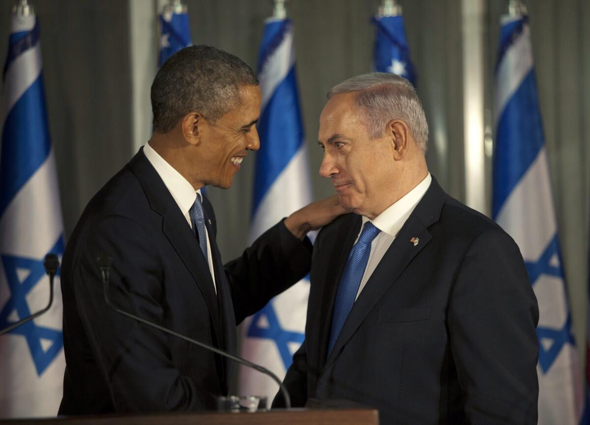 President Barack Obama, left, pats the shoulder of Israeli Prime Minister Benjamin Netanyahu during a joint news conference in Jerusalem, Israel.