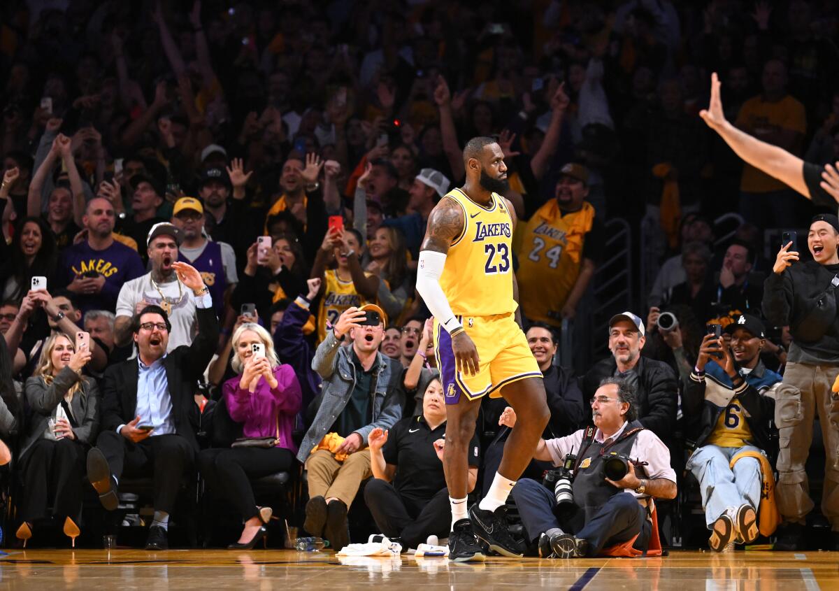 Lakers star LeBron James looks into the cheering crowd at Crypto.com Arena after scoring a basket.