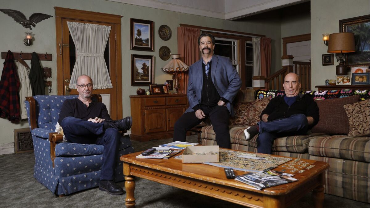 "The Conners" executive producers Bruce Rasmussen, left, Dave Caplan, center, and Bruce Helford, are photographed on the set.