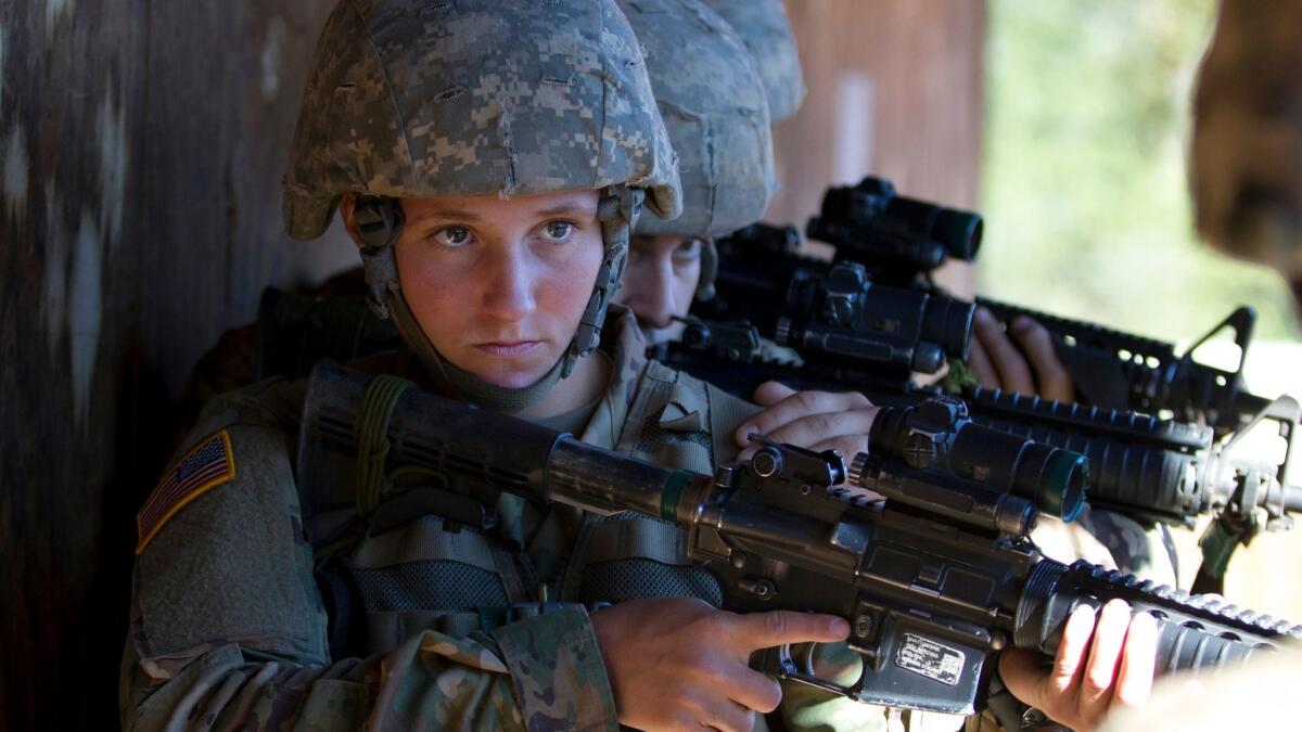 In this Oct. 4, 2017, photo, a female U.S. Army recruit practices building-clearing tactics with male recruits at Ft. Benning, Ga. The Army's introduction of women into the infantry has moved steadily but cautiously this year.